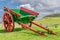 A red and green painted small horse pulled wagon