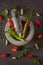 Red and green peppers in a stone dishware on a table