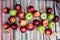 Red and green ripe apples lie on an authentic carpet. Autumn, harvesting