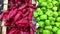 Red and green sweet bell peppers are on sale in supermarket, close up view as a background