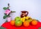Red and green tablecloth with pears, bananas, oranges and fresh green apples