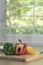 Red-green yellow bell pepper on a wooden cutting board To wait for cooking. real image.