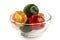 Red, green and yellow glace cherries in glass bowl isolated on w