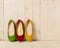 Red, green and yellow women`s shoes ballerinas on wooden backg