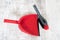 Red and grey dustpan and brush