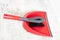 Red and grey dustpan and brush