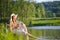 Red hair romantic woman relax by lake with book