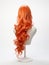 Red hair wig on a woman mannequin on white background.