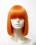 Red hair wig on a woman mannequin on white background.