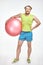 Red haired, bearded, plump man is holding fitness ball