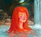 Red-haired beautiful girl bathes in a pond, in a thermal spring. Natural spa, relaxation