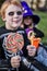 Red haired boy wearing halloween skeleton costume and holding colorful candies