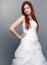 Red haired bride on gray background