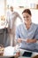 Red-haired caregiver sitting and organizing pills for patient