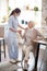 Red-haired caregiver in uniform speaking with patient