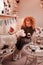 Red-haired curly woman celebrating birthday of her dogs