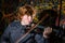 Red-haired freckled boy playing violin with different emotions o