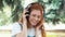 Red-haired freckled teenager dancing in park