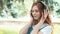 Red-haired freckled teenager dancing in park