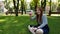 Red-haired girl blows soap bubbles in the park