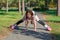 Red-haired girl with braids riding on rollers and falls in the p