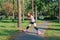 Red-haired girl with braids skates on pink rollers and falls in