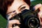 Red-haired girl with green eyes taking pictures camera in the ci