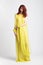 Red-haired girl in long elegant yellow dress