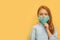 Red haired girl with mask on face, coronavirus