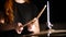 Red-haired girl plays music drums in a dark studio. Hands, drum sticks.