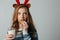 Red-haired girl with red horns in a sweater is very fond of milk with cookies a night. She did not wait for Santa and