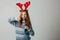 Red-haired girl refuses soda at Christmas so as not to harm sugar with her health. teenager with red deer horns before