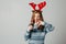 Red-haired girl refuses soda at Christmas so as not to harm sugar with her health. teenager with red deer horns before