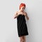 Red-haired girl wrapped in a black towel, front view, product photography for presentation