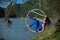 Red-haired gymnast in a blue suit doing the difficult exercises at the air ring in nature