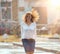 Red-haired happy woman in the rain