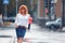 Red-haired happy woman in the rain