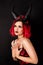 Red-haired model with horns. Halloween