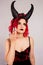 Red-haired model with horns. Halloween