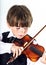 Red-haired preschooler boy with violin