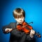 Red-haired preschooler boy with violin, music concept