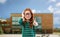 Red haired student girl in glasses over school