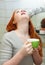 Red-haired teen girl gargling throat