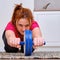 A red-haired woman does a fitness workout to strengthen the abdominal press. Exercise at home in the kitchen during isolation due