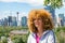 Red-haired woman in front of the skyline of Calgary