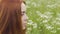 Red haired woman look outdoors, calm and tranquil female concentrated in field
