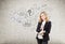 Red haired woman with notebook and startup idea sketch on concrete wall