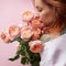 red-haired woman is sniffing roses media