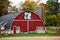 A red half circle quilt barn