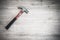 Red hammer on wooden floor, interior construction tool or home fixing renovation concept, dark tone abstract with vignette effect